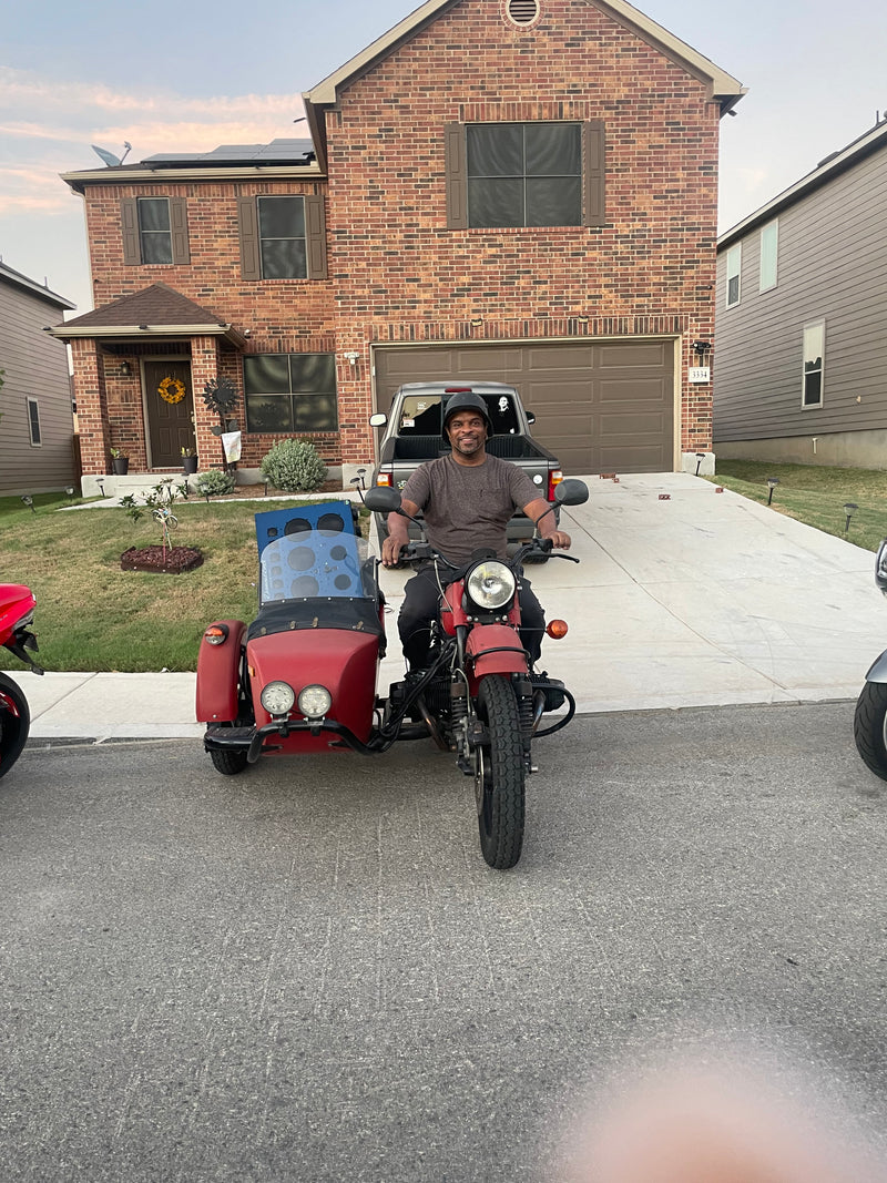 Burtris on his motorcycle with a blue DiamondBoxx XL2 in the sidecar.