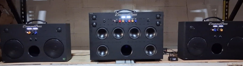 Two L3 speakers and an XLretro on a shelf in a customer work setup.